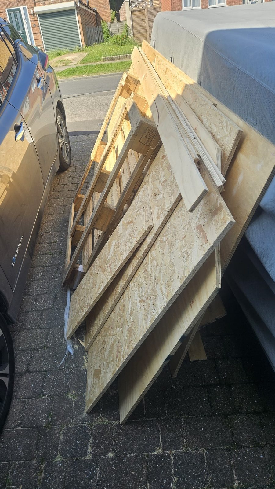 Timber boards and sheet material prepared for waste collection from a side access area